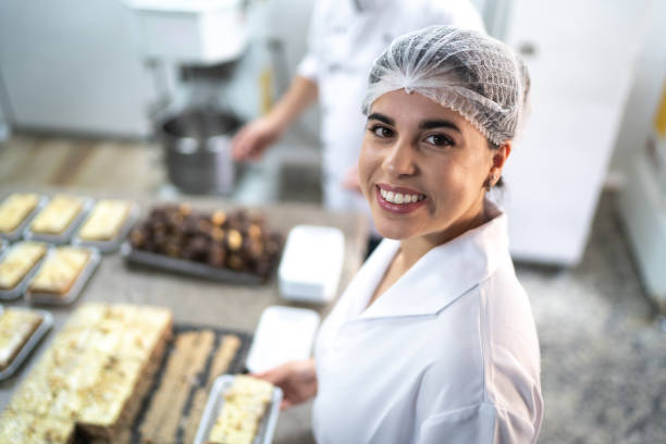 istock Portrait of a female baker preparing cakes in a commercial kitchen 1268305466