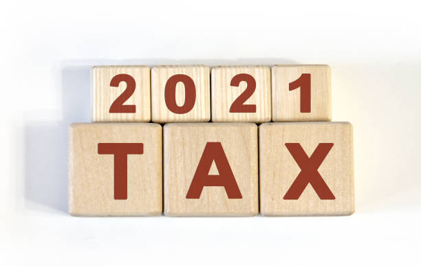 istock Text - tax 2021 on wooden cubes, on wooden background 1268305974