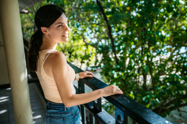 istock Young woman relaxing on balcony 1268307341