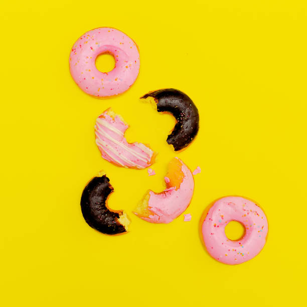 istock Donuts on a yellow background. Flat lay minimal art. Donuts lover idea 1268307478