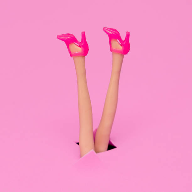 Doll legs in stylish heel shoes. Fashion flat lay minimal concept art stock photo