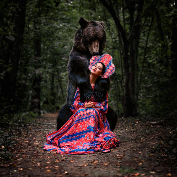 istock girl with a bear in the summer forest 1268314848
