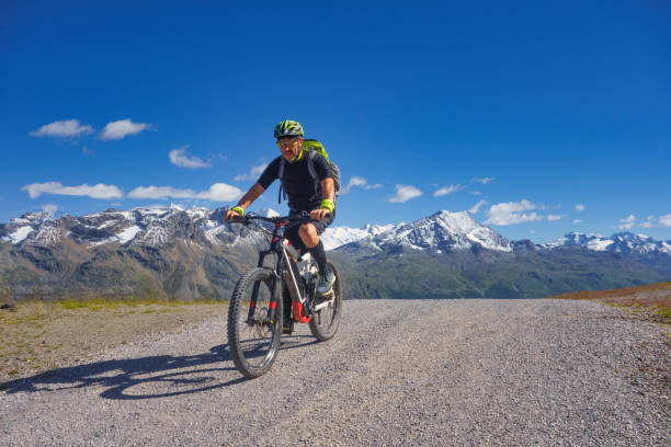 istock Mountain biking in the high mountains on a dirt road 1268316070