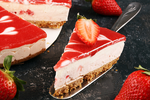 Delicious strawberry cheesecake with berries on grey table