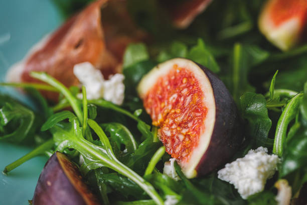 Delicious fig salad with arugula, prosciutto and goat cheese