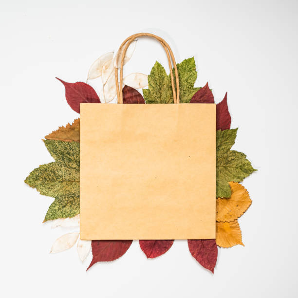 istock Autumn sale. Dry multicolored leaves on a light background. Blank paper for text. 1268329665