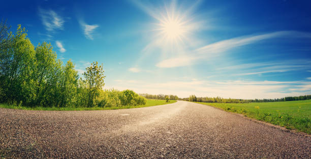 istock Asphalt road panorama in countryside on sunny spring day 1268330725