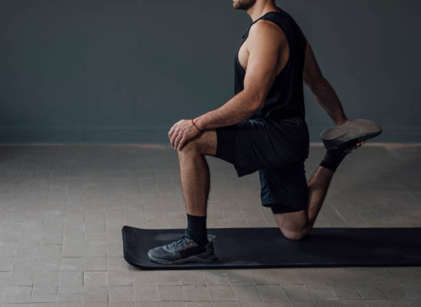 istock Anonymous Man in Black Sportswear Warming Up before the Workout 1268332662