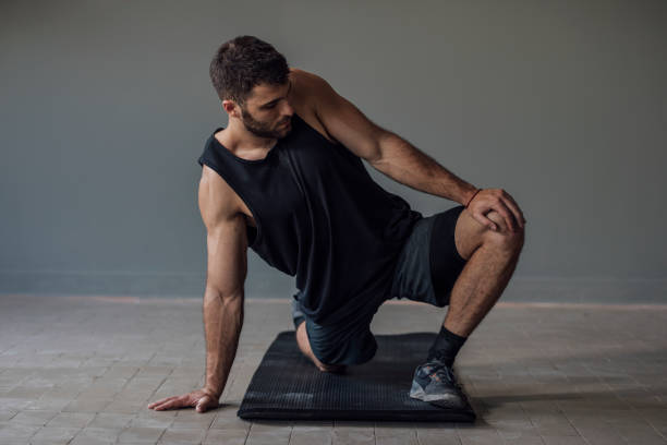 istock Man in Sportswear Warming Up before the Workout 1268332688