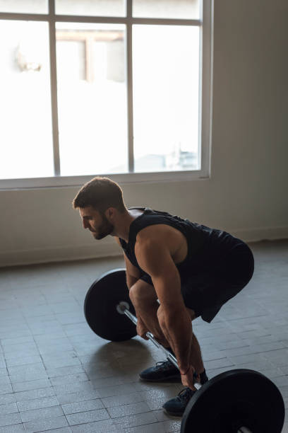istock Athlete Exercising by Lifting Barbells, cross training Strength Training Concept 1268332692
