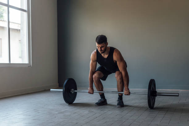 istock Athlete Exercising by Lifting Barbells, cross training Strength Training Concept 1268332697