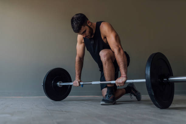 istock Athlete Exercising by Lifting Barbells, cross training Strength Training Concept 1268332704