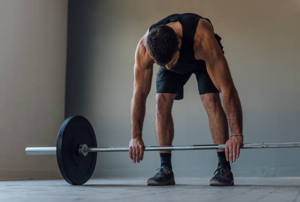 istock Athlete Exercising by Lifting Barbells, cross training Strength Training Concept 1268332711