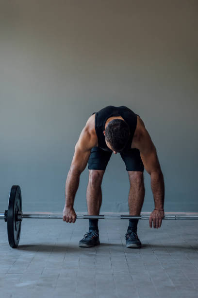 istock Athlete Exercising by Lifting Barbells, cross training Strength Training Concept 1268332717