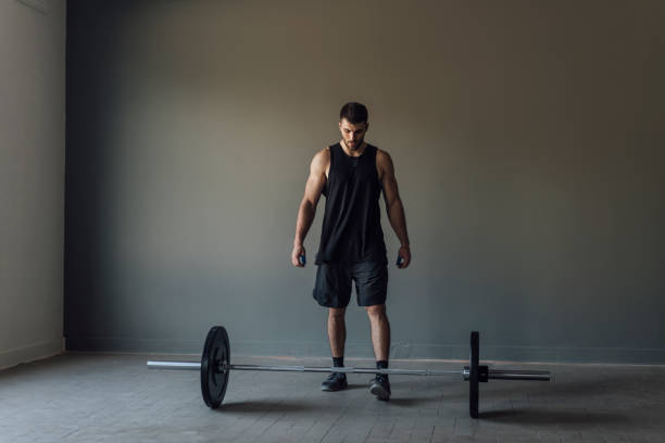 istock Athlete Exercising by Lifting Barbells, cross training Strength Training Concept 1268332724