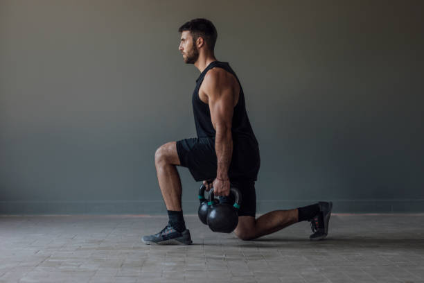 Man Exercising legs Kettlebells ripl fitness
