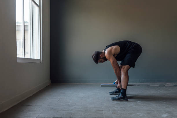 istock Athlete Exercising by Lifting Barbells, cross training Strength Training Concept 1268332731