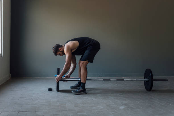Athlete Exercising by Lifting Barbells, cross training Strength Training Concept