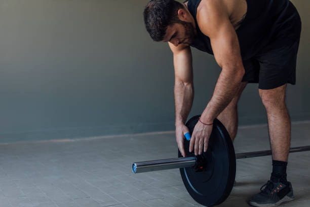 istock Athlete Exercising by Lifting Barbells, cross training Strength Training Concept 1268332739