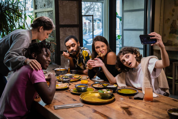 istock Group of young students making faces, taking pictures with their 1268339244
