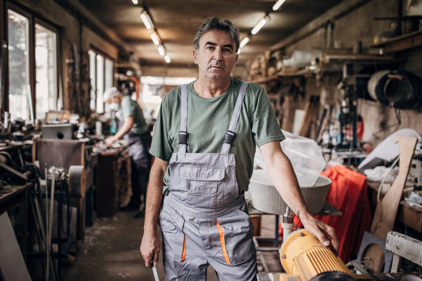 istock Portrait of a senior man who is standing in workshop 1268340831