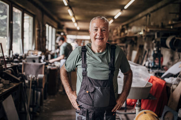 istock Portrait of a senior man who is standing in workshop 1268340891