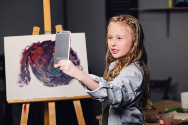 istock a young charming artist leads an online masterclass in drawing pictures in her workshop 1268341067