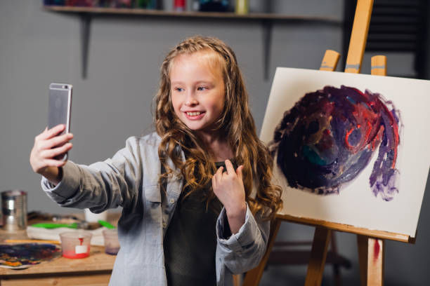 istock a young blogger broadcasts from an art Studio where she draws an abstract picture 1268341074