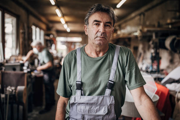 istock Portrait of a senior man who is standing in workshop 1268341187