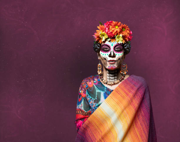 Woman with ceremonial make-up also known as Sugar skull, used in traditional Mexican Dia de los Muertos celebration.