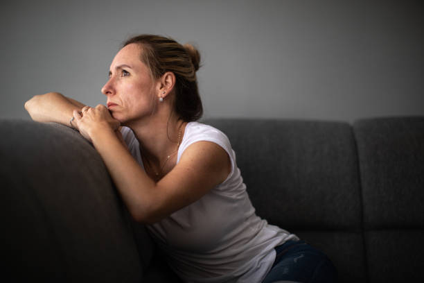 istock Depressed mid-aged woman at home feeling sad, lonely, anxious 1268342224