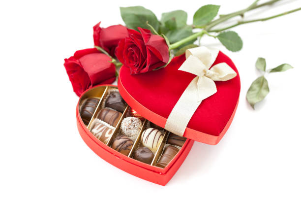 istock Valentine's Day Box of Chocolates and Red Roses Isolated on White 1268342264