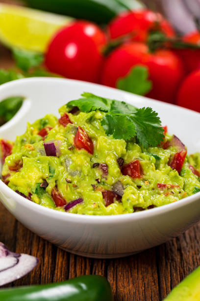 istock Avocado Guacamole Mexican Dip with Avocado, Lime, Tomato and Cilantro 1268344121