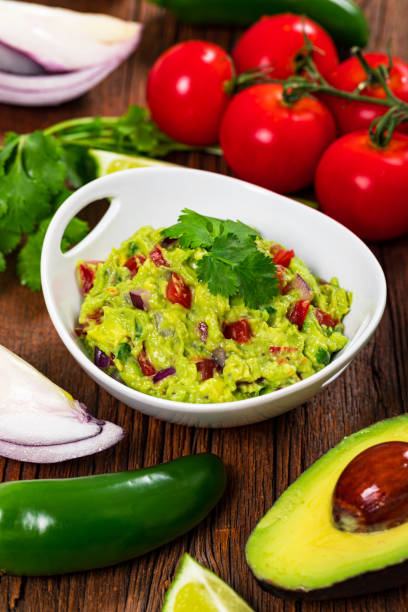 istock Avocado Guacamole Mexican Dip with Avocado, Lime, Tomato and Cilantro 1268345004