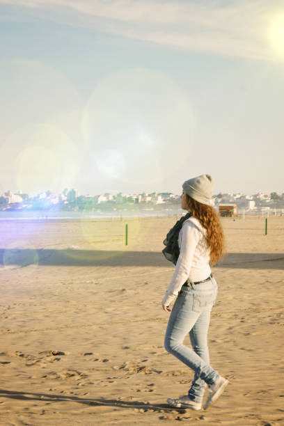 istock girl walking in the beach 1268345036