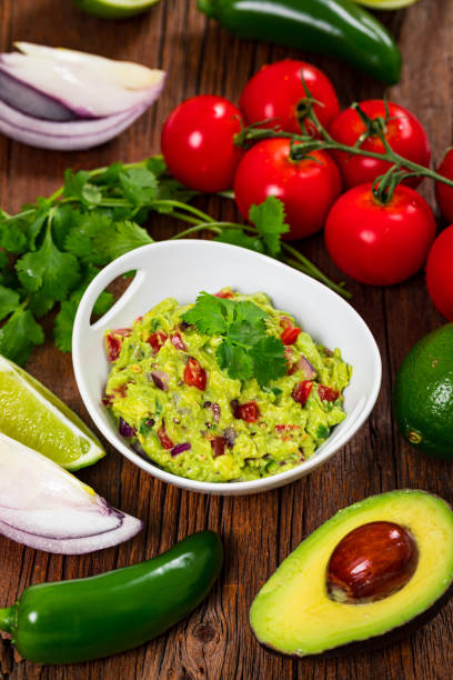 istock Avocado Guacamole Mexican Dip with Avocado, Lime, Tomato and Cilantro 1268345117