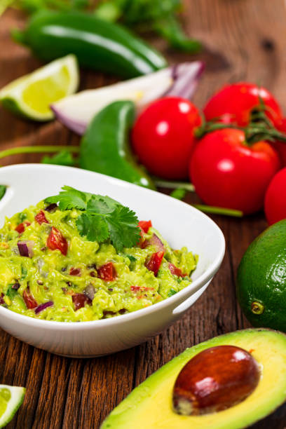 istock Avocado Guacamole Mexican Dip with Avocado, Lime, Tomato and Cilantro 1268345133
