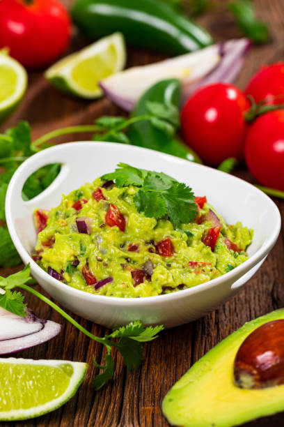 istock Avocado Guacamole Mexican Dip with Avocado, Lime, Tomato and Cilantro 1268345159