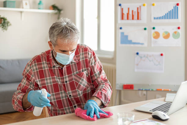istock Cleaning With Antivirus Wet Wipe a Working Office Desk 1268346027