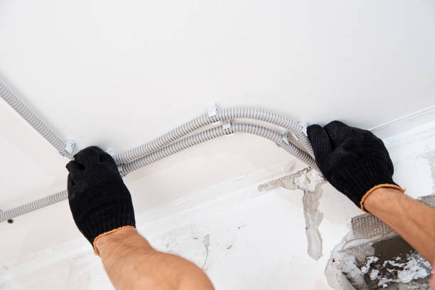 istock Electrician fixing electric cable to the wall, closeup 1268346133