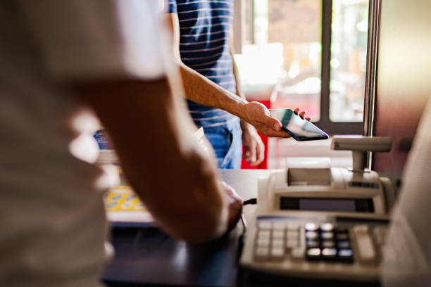 istock Shop owner receives wireless contactless payment from a customer 1268348445