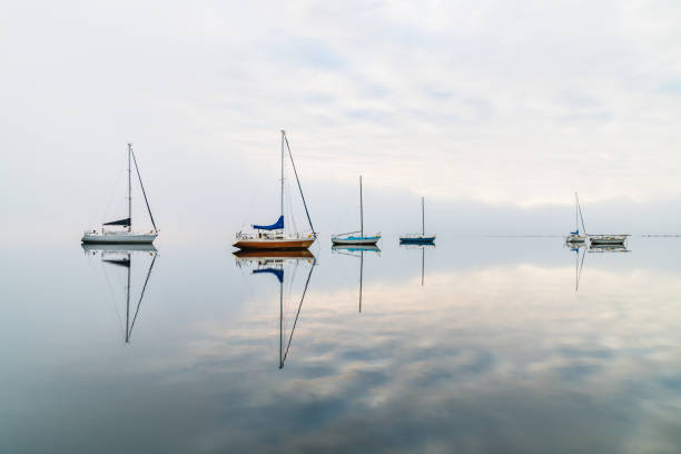 istock Misty Morning with Boats and Reflections on the Bay 1268354411