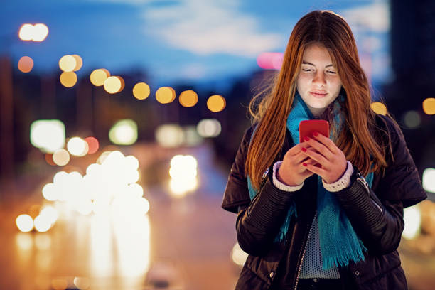 istock Young girl is texting on the bridge at night 1268355059