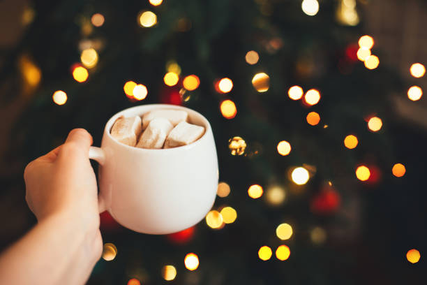 istock Cocoa with marshmallows in woman hand. 1268356273