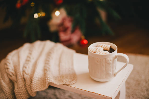 istock Hot cocoa with marshmallows near Christmas tree. 1268356296