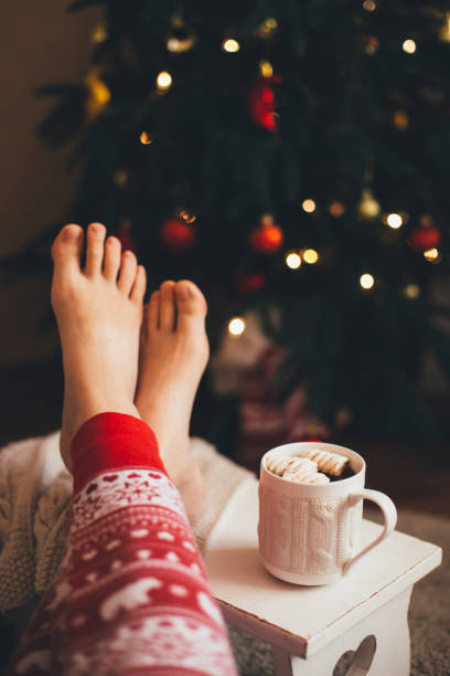 istock Hot cocoa with marshmallows near Christmas tree. 1268356330