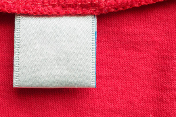 istock White blank laundry care clothes label on red cotton shirt background 1268358353