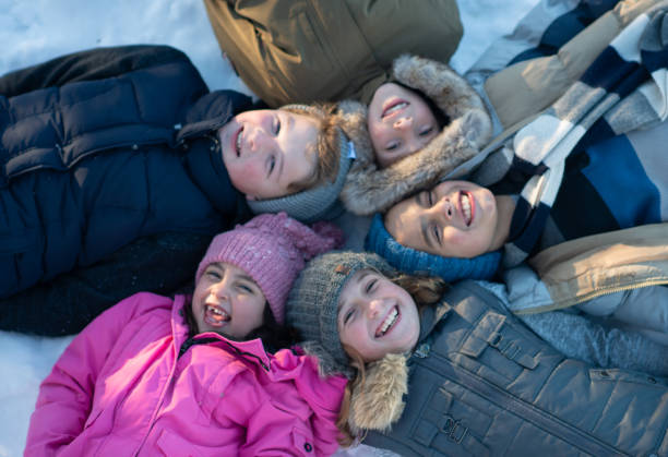 istock Kids playing in the snow 1268358690