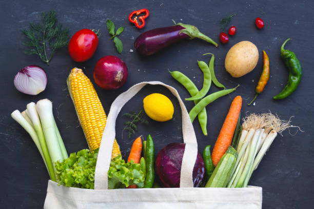 istock Eco bag vegetables and fruit on a dark background with copy space top view. Bag food concept 1268366110