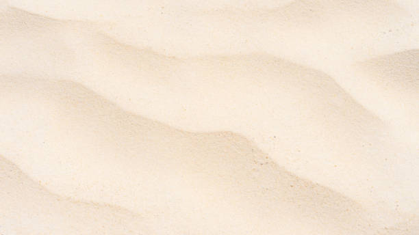 istock Beautiful sand texture in summer sun as background. 1268368713